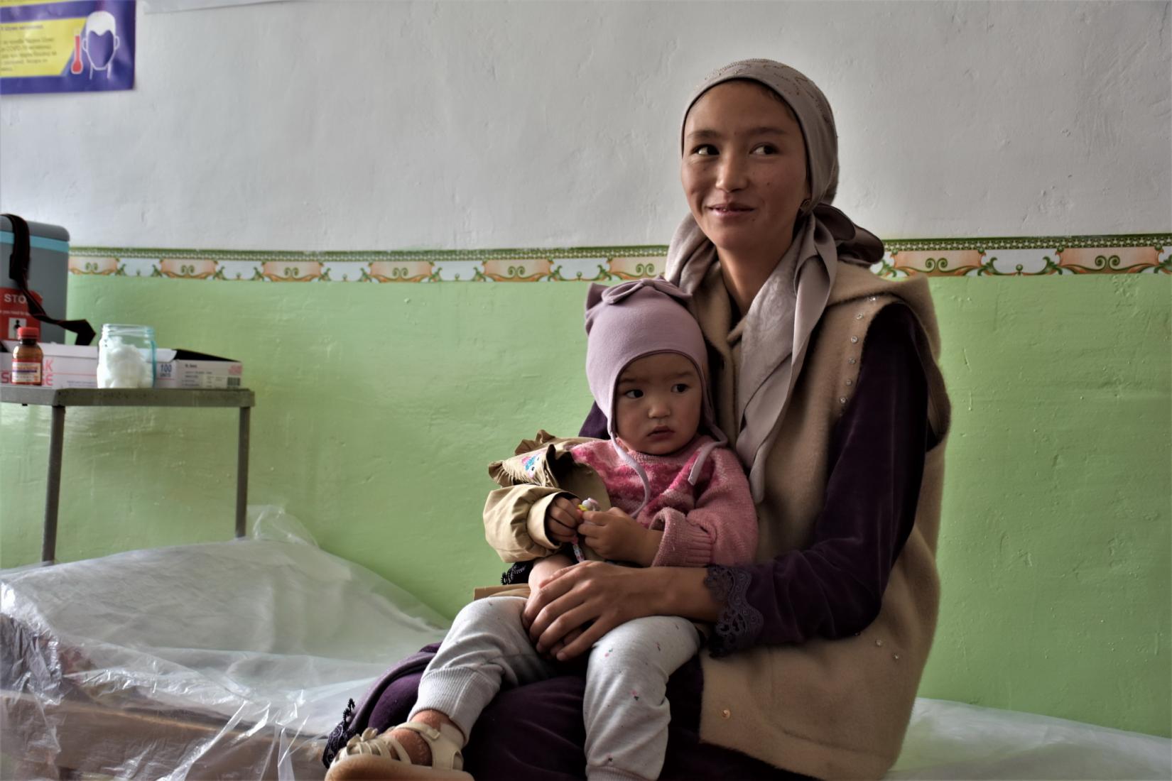 Mother and daughter, waiting for the MMR vaccine at the PHC facility in Murghab
