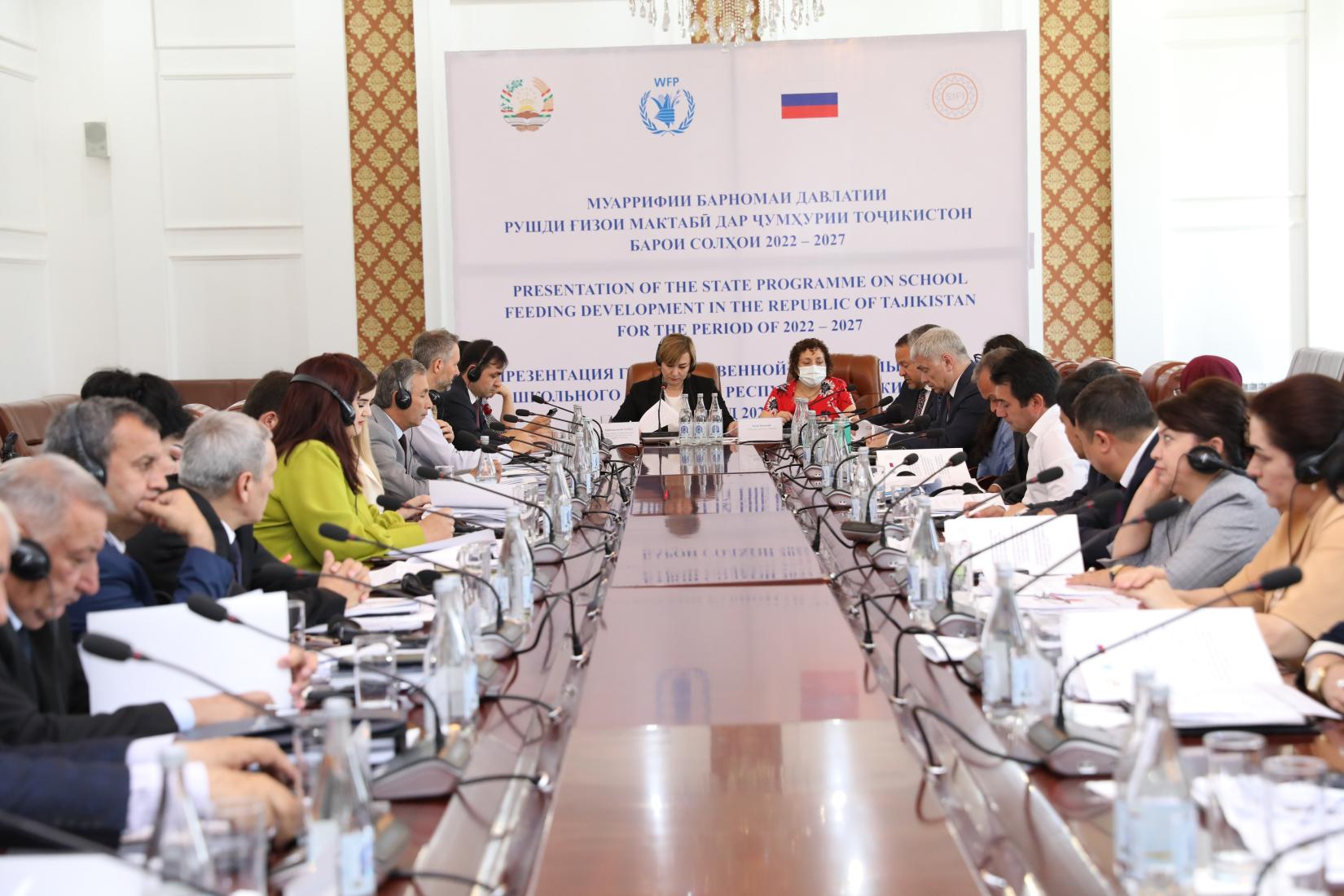 A group of people sitting around the table in the conference