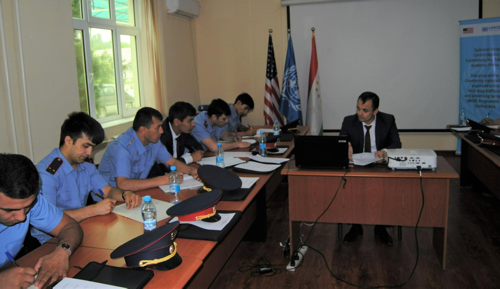 A group of people sitting around the table in the training