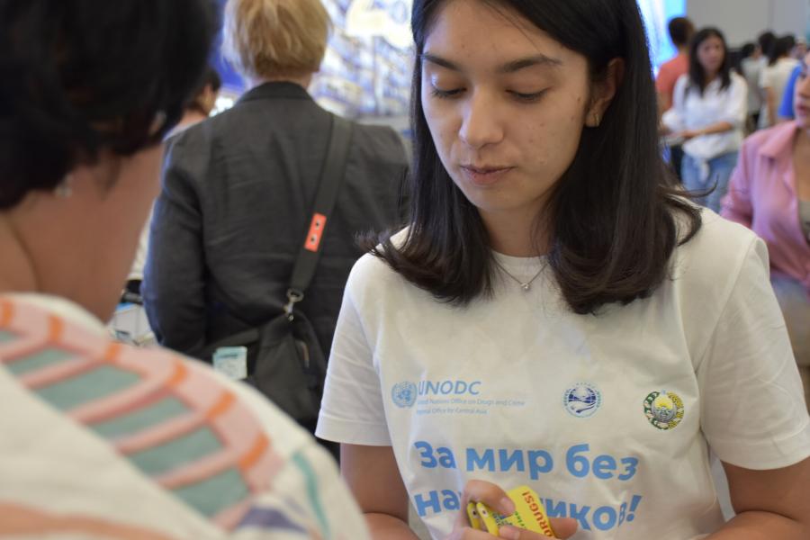 A girl talks to a person at the information event